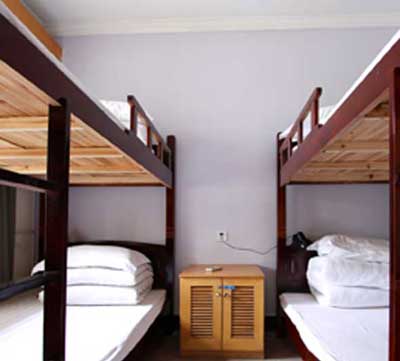 brown wooden bed frame with white bed linen